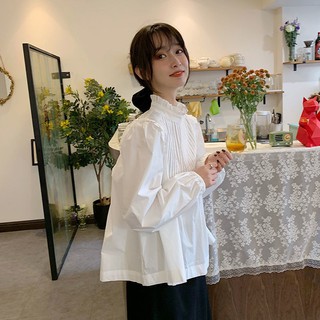 เสื้อเชิ้ตผู้หญิงออกแบบความรู้สึกสวมใส่ย้อนยุค 2020 ใหม่ฤดูใบไม้ร่วงรุ่นเกาหลีสีขาวหลวมแขนยาวเสื้อคอปกยืนขึ้น