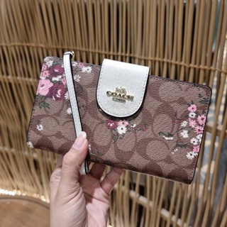 COACH TECH PHONE WALLET IN SIGNATURE CANVAS WITH EVERGREEN FLORAL PRINT