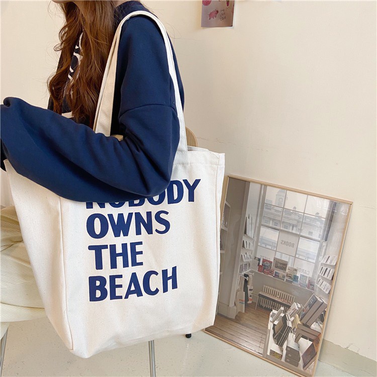 bag-1-bag1783-กระเป๋าผ้าใบใหญ่-nobody-owns-the-beach-ผ้าแคนวาสมี4สาย