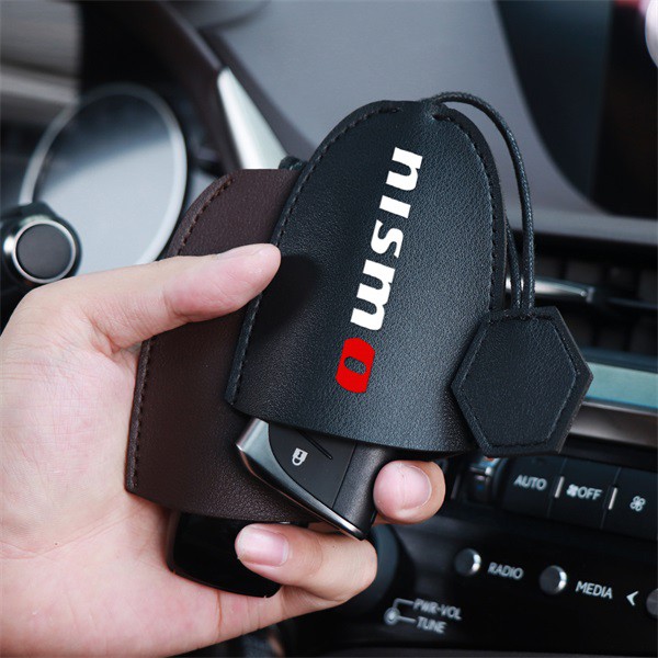ภาพหน้าปกสินค้าซองใส่กุญแจอัตโนมัติ Key Fob Nissan Nismo Tiida Teana Skyline Juke X-Trail กุญแจรีโมทรถยนต์พวงกุญแจหนัง
