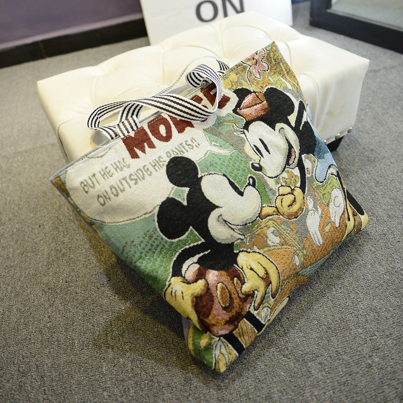 ภาพหน้าปกสินค้ากระเป๋าผ้าใบสะพายไหล่ลายการ์ตูน Mickey จากร้าน newone2.th บน Shopee