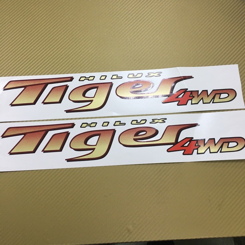 สติกเกอร์-tige-d4d-4wd-ติดข้างท้ายกระบะ-toyota-hilux-ปี-2002-ราคาต่อคู่-มี-2-ชิ้น