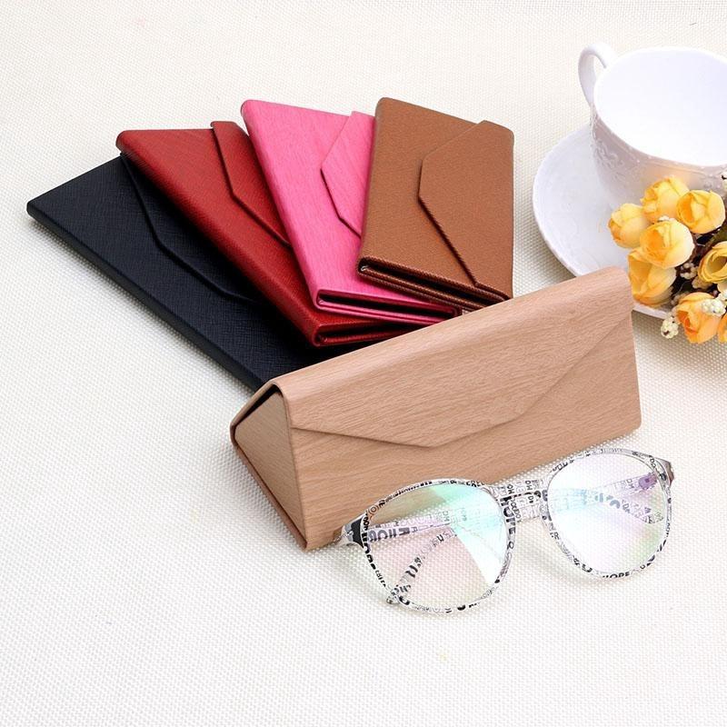 ภาพหน้าปกสินค้าTriangular Folding Glasses Case High-Grade Leather Wood Box Plain Mirror Sunglasses Case ซึ่งคุณอาจชอบราคาและรีวิวของสินค้านี้