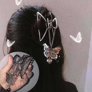 A metal hairpin in the shape of a butterfly, designed for women.