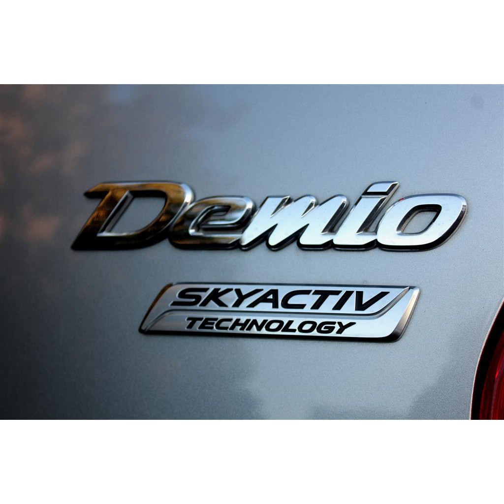 โลโก้-demio-ติดท้ายรถ-สำหรับ-mazda-2-skyactiv-และ-mazda-2-โฉมเก่า-logo-demio-เดมิโอ้-mazda2