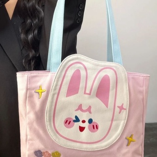 MEW👜bag ผู้หญิง 2022 ใหม่กระเป๋าโท้ตญี่ปุ่นน่ารักทุกการแข่งขันกระเป๋าสะพายผ้าใบกระเป๋านักเรียนระดับวิทยาลัย