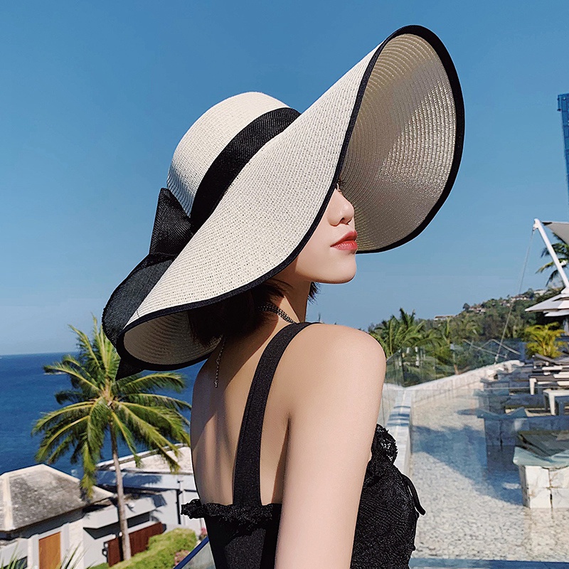ภาพหน้าปกสินค้าหมวกสานผู้หญิง หมวกปีกกว้าง ขอบสีดำ โบว์สีดำ รุ่นA003 สีขาว ครีม กากี จากร้าน saladxu บน Shopee