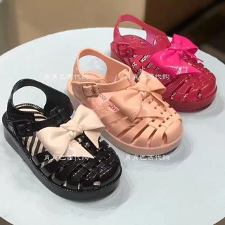 Mini Melissa รองเท้าแตะ พื้นนิ่ม ประดับโบว์ แต่งรูกลวง สไตล์โรมัน สําหรับเด็กผู้หญิง