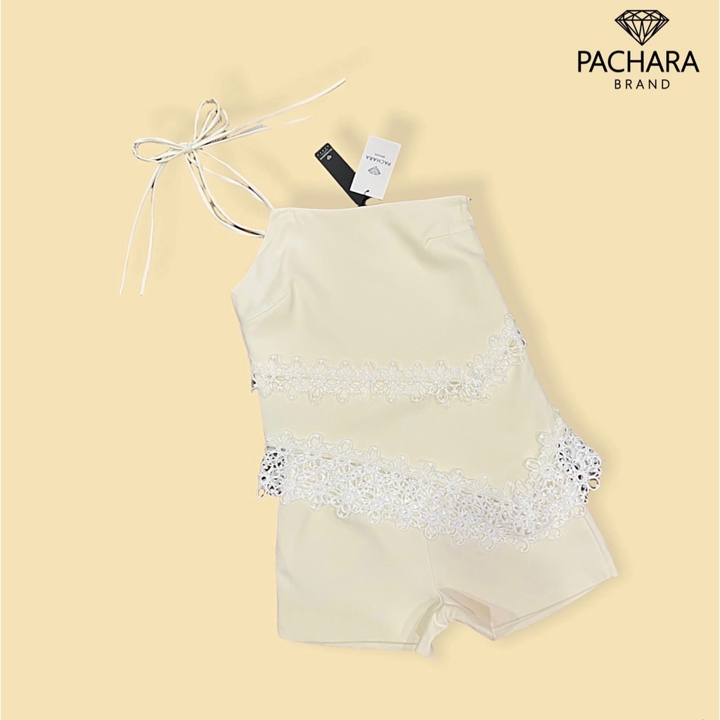 pachara-เซ็ต-2-ชิ้น-เสื้อผูกไหล่ด้านเดียวสีครีม-ชายเสื้อเฉียงแต่งลูกไม้สีขาว-แมทช์คู่กับกางเกงขาสั้นเอวสูง