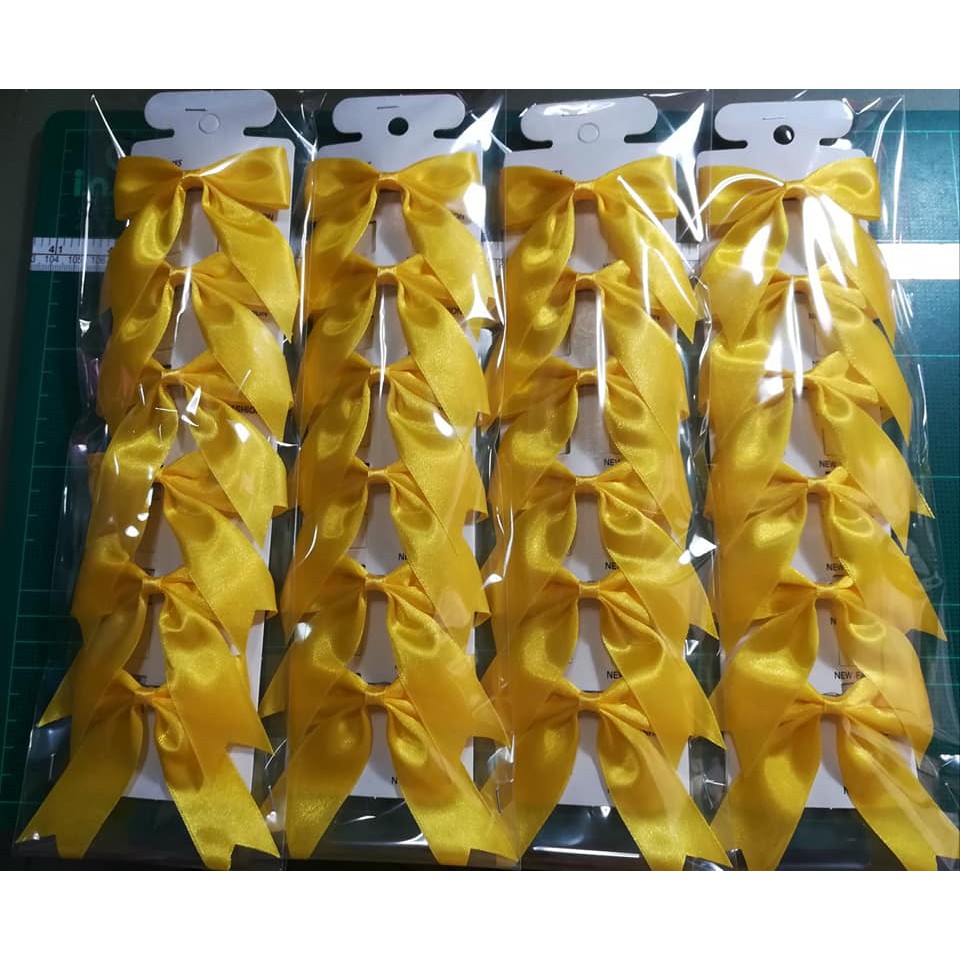 ภาพหน้าปกสินค้าโบว์กิ๊บสีเหลือง  1 แพ็ค จากร้าน duangdao_2020 บน Shopee