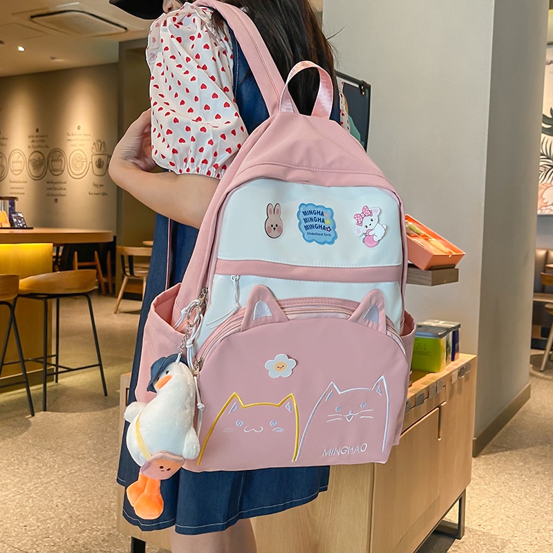ภาพหน้าปกสินค้ากระเป๋านักเรียน กระเป๋าเป้สะพายหลัง กระเป๋านักเรียน ลําลอง ขนาดใหญ่ จุของได้เยอะ ลายการ์ตูนน่ารัก สไตล์เกาหลี สําหรับผู้หญิง