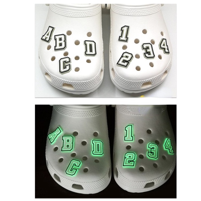 ภาพหน้าปกสินค้าจดหมายเรืองแสงในที่มืด น่ารัก สําหรับ Croc Shoe Charms Luminous Jibitz Letters Jibits Crocks สําหรับผู้ชาย ตกแต่งรองเท้า จากร้าน keduoduo.th บน Shopee
