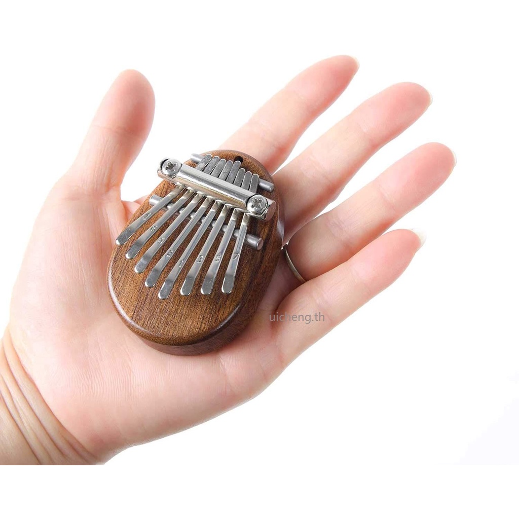 ภาพหน้าปกสินค้าคาลิมบา 8 คีย์ เเบบพวงกุญเเจ 8 Key Mini Kalimba exquisite Finger Thumb Piano Marimba Musical good accessory Pendant Gift จากร้าน uicheng.th บน Shopee