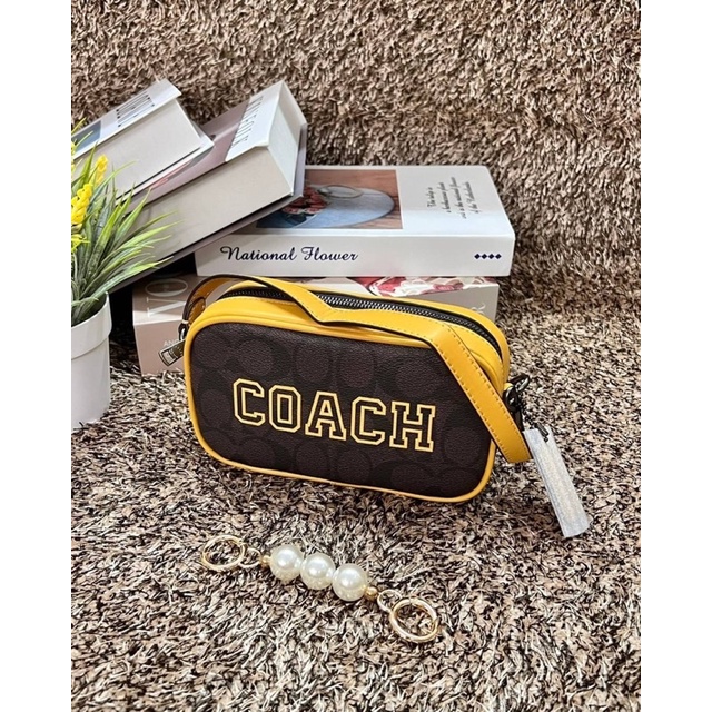coach-jamie-wristlet-in-signature-canvas-with-varsity-motif