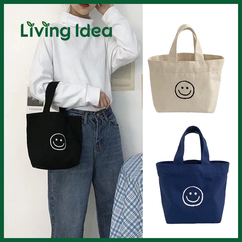 ภาพหน้าปกสินค้าLiving Idea  กระเป๋าถือ สไตล์เกาหลี แฟชั่นน่ารัก smiley พร้อมส่ง กระเป๋าผ้าแคนวาส ขนาดมินิ จากร้าน living.idea บน Shopee