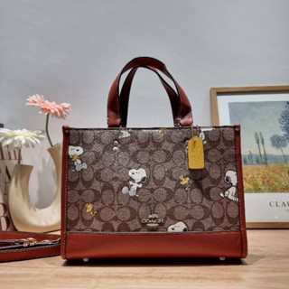 COACH x PEANUTS DEMPSEY CARRYALL IN SIGNATURE CANVAS WITH SNOOPY WOODSTOCK PRINT