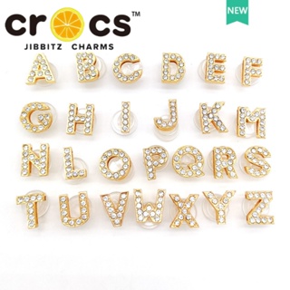 ภาพหน้าปกสินค้าJibbizt กระดุมโลหะ รูปตัวอักษร สีทอง อุปกรณ์เสริมสําหรับตกแต่งรองเท้า Crocs ที่เกี่ยวข้อง