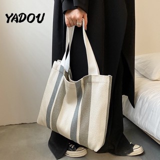 YADOUใหม่ เวอร์ชั่นเกาหลี แฟชั่น กระเป๋าสะพาย ไม่เป็นทางการ วรรณคดีและศิลปะ แถบ ผ้าใบ ความจุสูง การเดินทาง ถุง