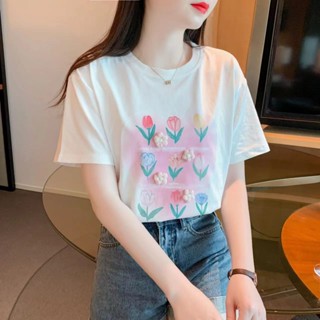 เสื้อยืดแขนสั้น ผ้าฝ้ายแท้ พิมพ์ลายดอกไม้ สามมิติ สีขาว แฟชั่นฤดูร้อน สไตล์ตะวันตก สําหรับผู้หญิง 2023
