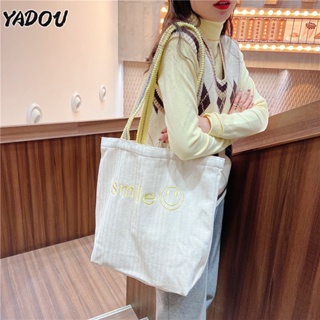 YADOU กระเป๋าสะพายไหล่สตรีสไตล์เกาหลีปักหน้ายิ้มความจุขนาดใหญ่สายสะพายไหล่ furball กระเป๋าผ้าใบระดับนักเรียน