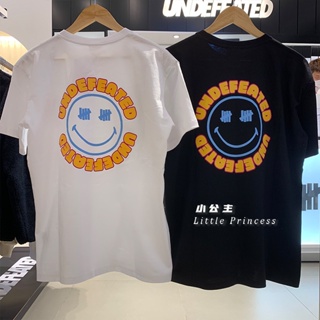 สินค้าใหม่ UNDEFEATED เสื้อยืดแขนสั้น คอกลม พิมพ์ลายหน้ายิ้ม ทรงหลวม สีพื้น