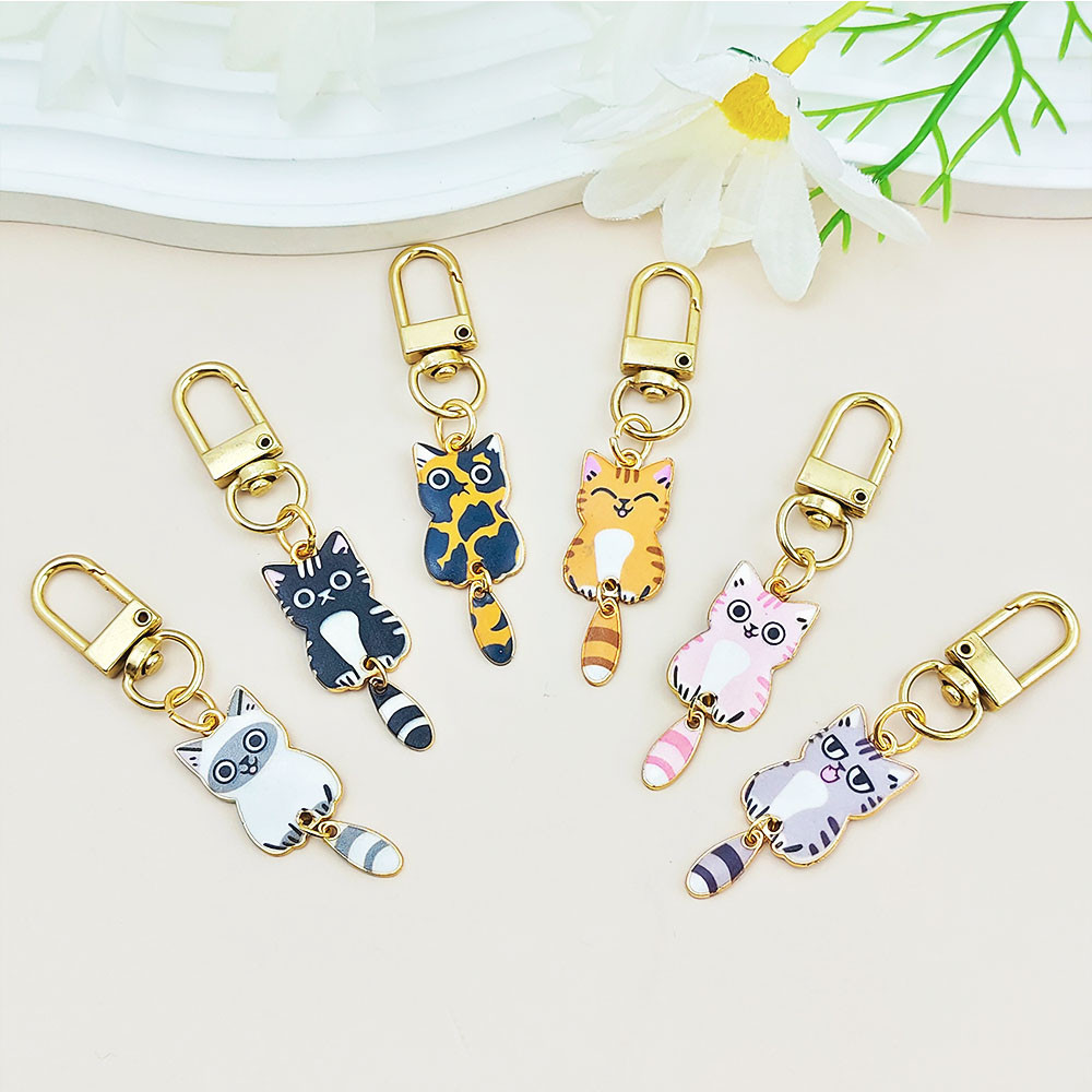 Kawaii Wagging Tail Cat Key แหวน Creative เคลือบลูกแมวโลหะพวงกุญแจหูฟัง ...