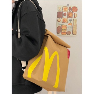☽﹍กระเป๋านักเรียนผ้าใบใหม่ของ McDonald s ปี 2023 INS กระเป๋าเป้สะพายหลังชั้นเดินทางถุงกระดาษ Messenger ความจุขนาดใหญ่