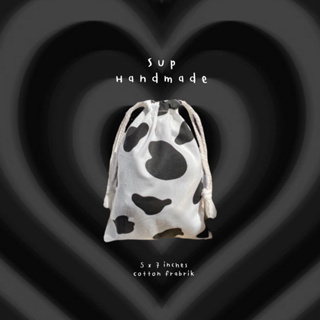 ภาพขนาดย่อของภาพหน้าปกสินค้าถุงหูรูดลายวัว น่ารักมาก จากร้าน sup_handmade บน Shopee