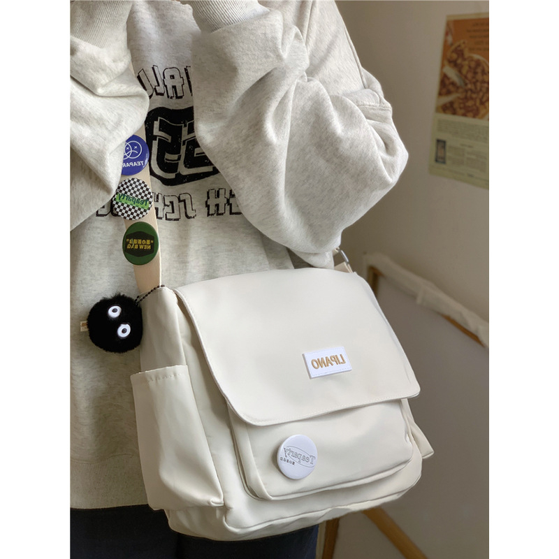 กระเป๋าผ้าแคนวาสสำนักความจุขนาดใหญ่สำหรับนักเรียนกระเป๋าสะพายไหล่ลำลองเรียบง่ายสไตล์ญี่ปุ่น