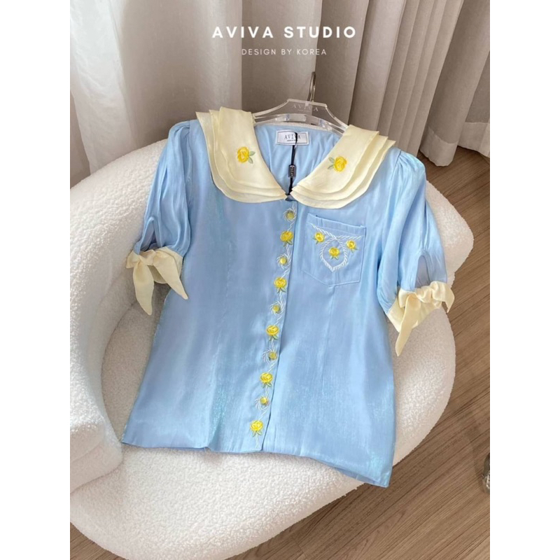 aviva-studio-เสื้อสีฟ้าผ้าเงา-ปักดอกเหลือง