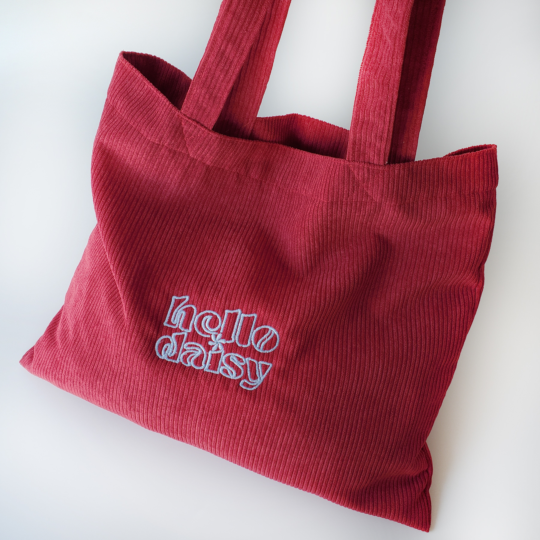 Hello Daisy- Cody tote กระเป๋าผ้าลูกฟูกทรงหมอน สีแดง งานปัก logo ...